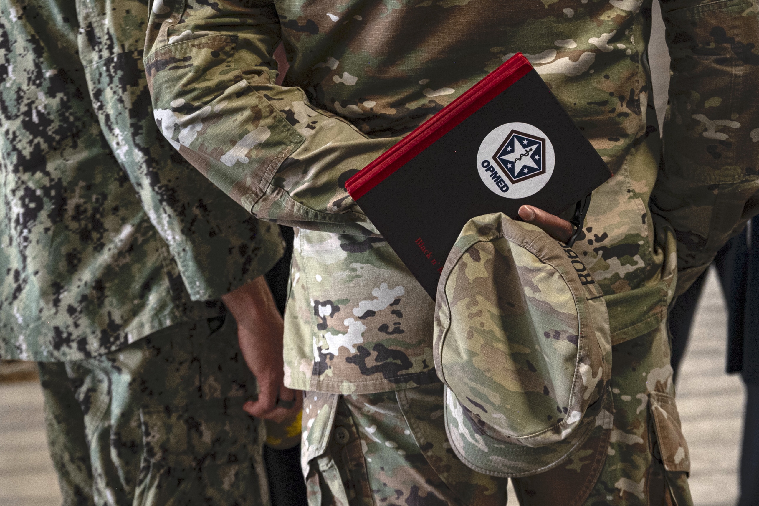 Soldier holding operational medicine book