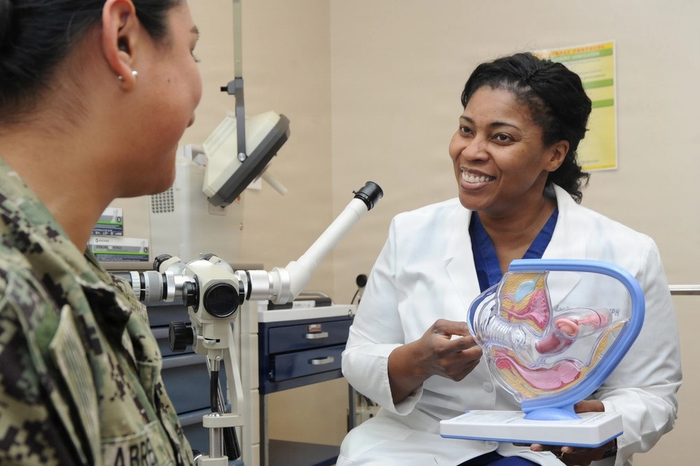 Physician discussing anatomy with uniformed service member